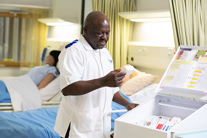 Nursing student looking at medication in a ward