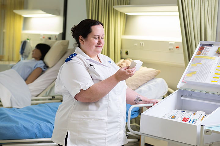 Nursing student looking at medication in the simulation ward