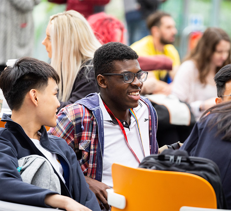 A group of students chatting and laughing