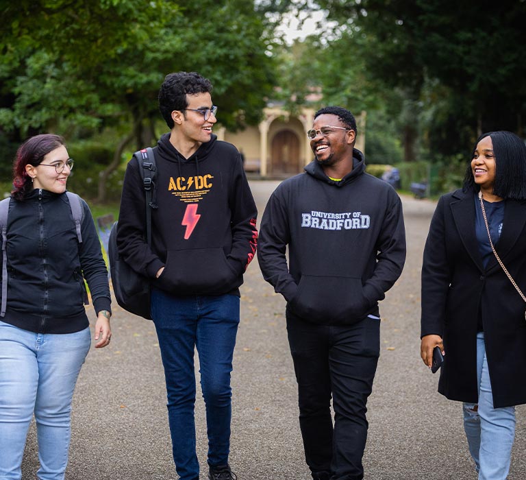 A group of four students walking together.