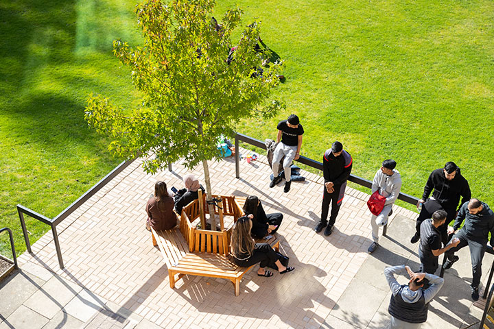 A group of students relaxing in the seating area of the Amp.