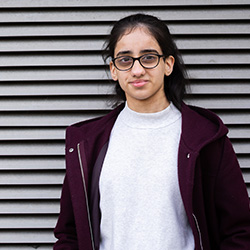 A student smiling at the camera