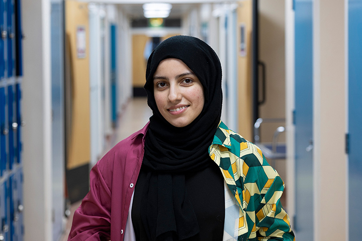 A student smiling at the camera