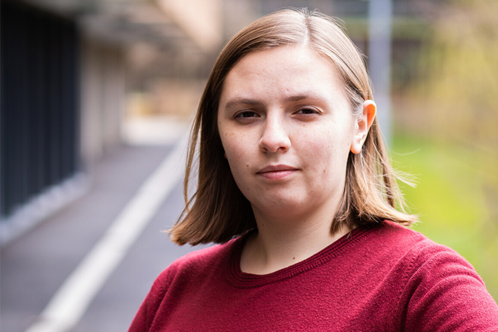 A student smiling at the camera