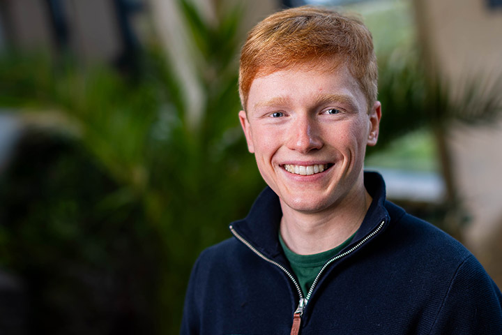 A student smiling at the camera