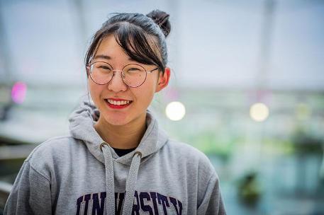 A student smiling at the camera