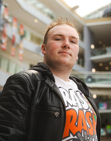 A student standing in the Richmond atrium at Bradford