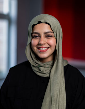 A student smiling at the camera