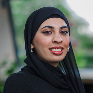 A student smiling at the camera