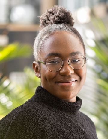 A student smiling at the camera