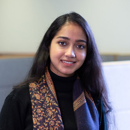 A head and shoulders photo of a person smiling at the camera.