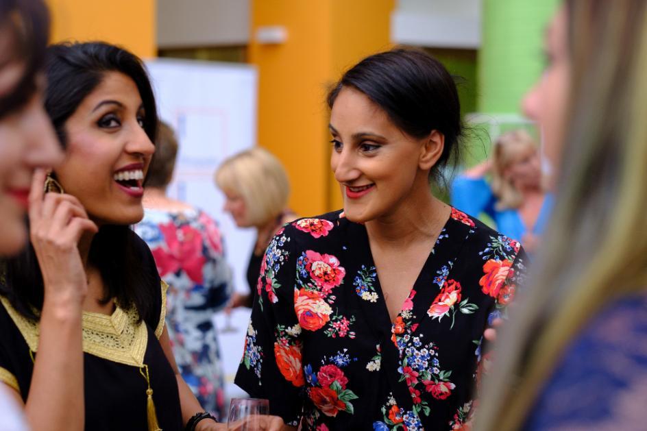 A group of females networking in the Atrium