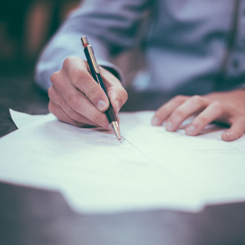 Person signing a document.