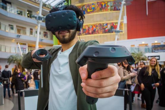 A student using a VR headset and controllers