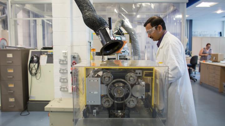 A scientist operating a piece of equipment