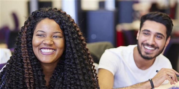 2 smiling students in classroom