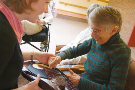 A female member of staff with a female dementia patient. Size for grid box.