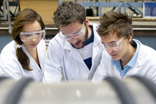 Three civil engineering students huddled together