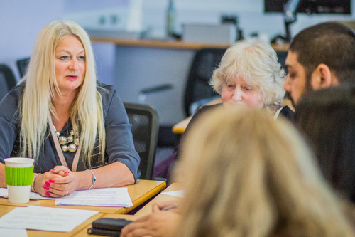 A group of people sitting around a meeting table.