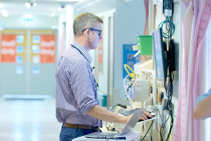 Donald Richardson looking at a computer screen in a hospital.