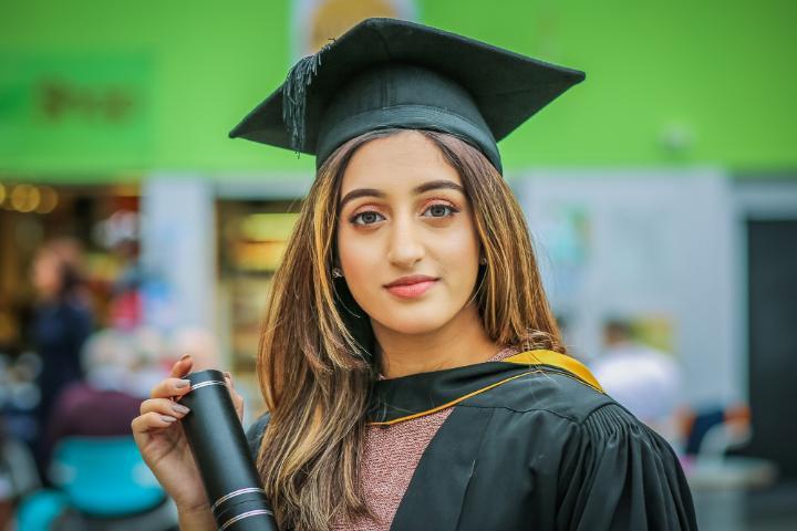 LLM Graduate wearing mortarboard and gown