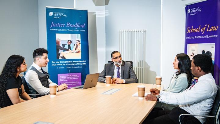 Students, academic and guests engaged in a School of Law, Law Clinic Session