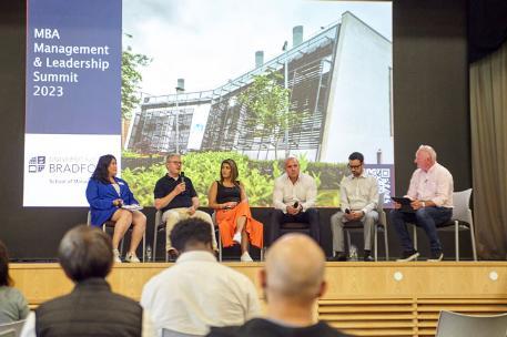 Guest speakers taking part in a panel discussion for the MBA Summit in Great Hall, 2023