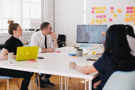 Room with business and students meeting to look at presentation