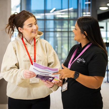 A member of the MyBradford support team talking to a student.