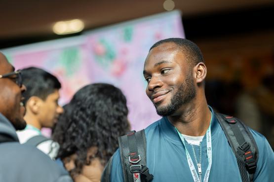 Student in backpack smiling during Freshers Fair 2024