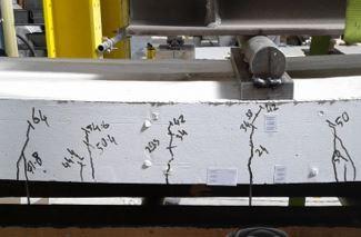 A block of so-called 'green concrete', which is more environmentally friendly, being stress tested in the lab