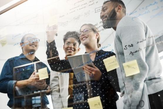 Workers gather to look at a display as part of a team building exercise