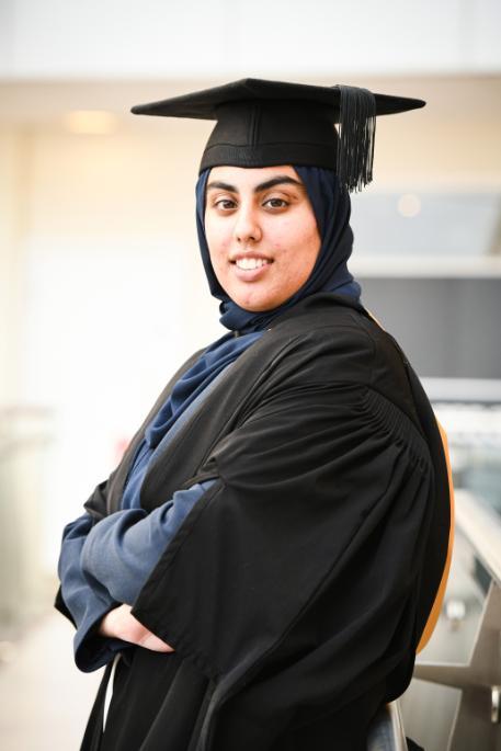 A student in graduation robes