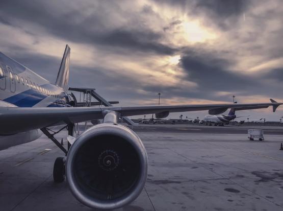 Image showing an aircraft wing and engine on a runway