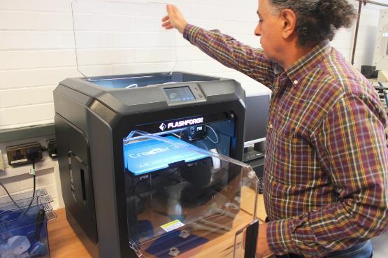 An academic sets up a 3D printer