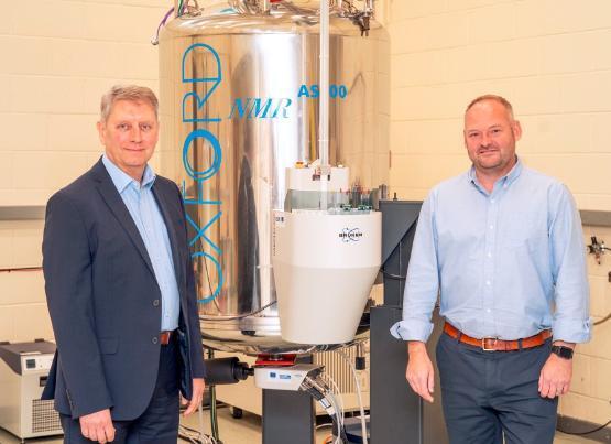 Dr Jason Jones and Dr Richard Telford look at an NMR machine