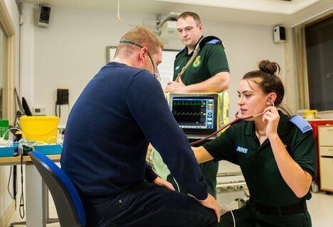 Two students attending a patient in class