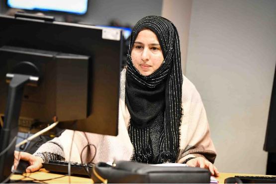 A student sat down at a desk in front of a computer screen