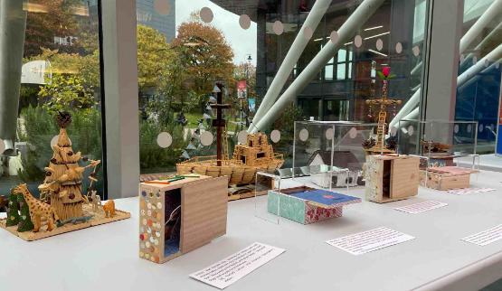 A number of small models made out of wood on a table