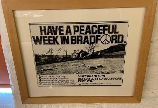 A wooden framed poster promoting tourism in Bradford