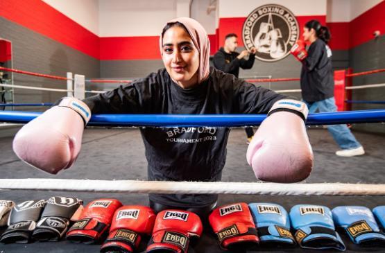 Dr Alaa Alshaabi wearing boxing gloves in the ring