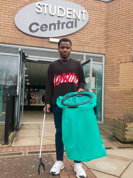 Sabbatical officer Rotimi Olorunfemi picking up litter