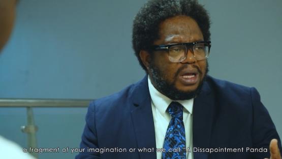 a person dressed in a suit sat down at a table