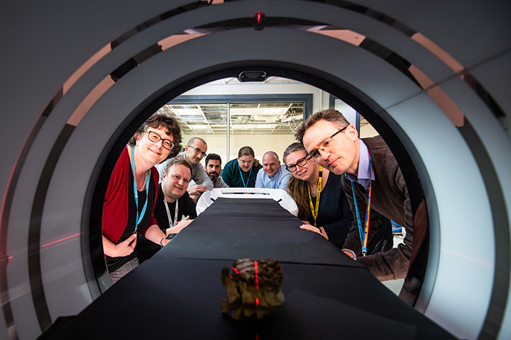 Members of the School of Archaeological and Forensic Sciences looking at an artifact in a CT machine.