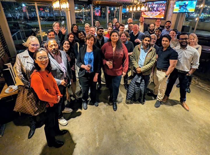 A group photo of around 30 Bradford alumni in a bar in Toronto Canada