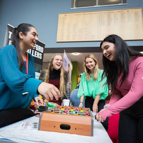 Students playing foosball in the Student Central atrium