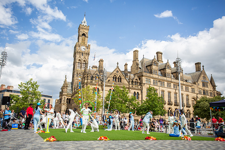 A group doing a performance at the BD Festival in front of City Hall