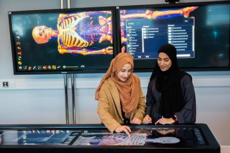 Two students using an anatomage table