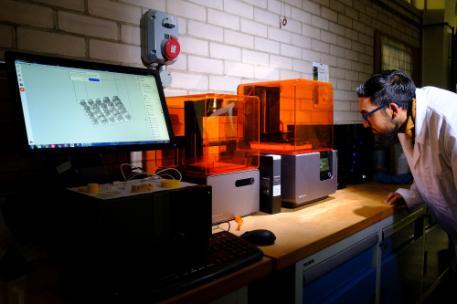 A student using a 3D printer at the Polymer IRC