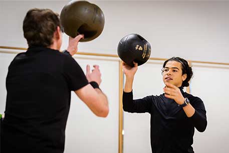 Two people with medicine balls